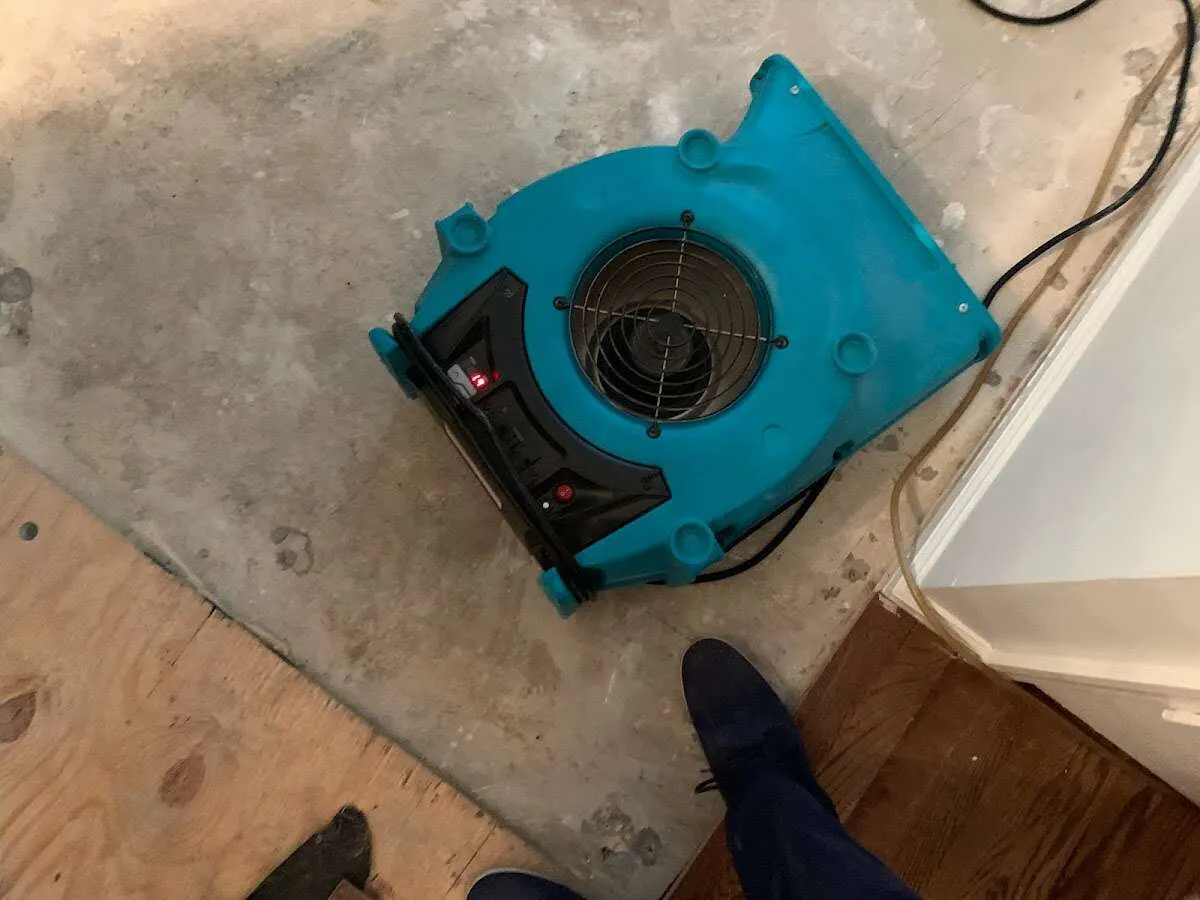 Air mover drying subfloor during Commercial Water Damage Restoration in Walden